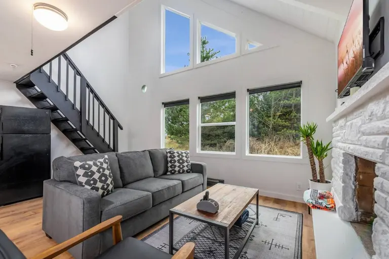 Living room and staircase in Tidal House Chalet 4.